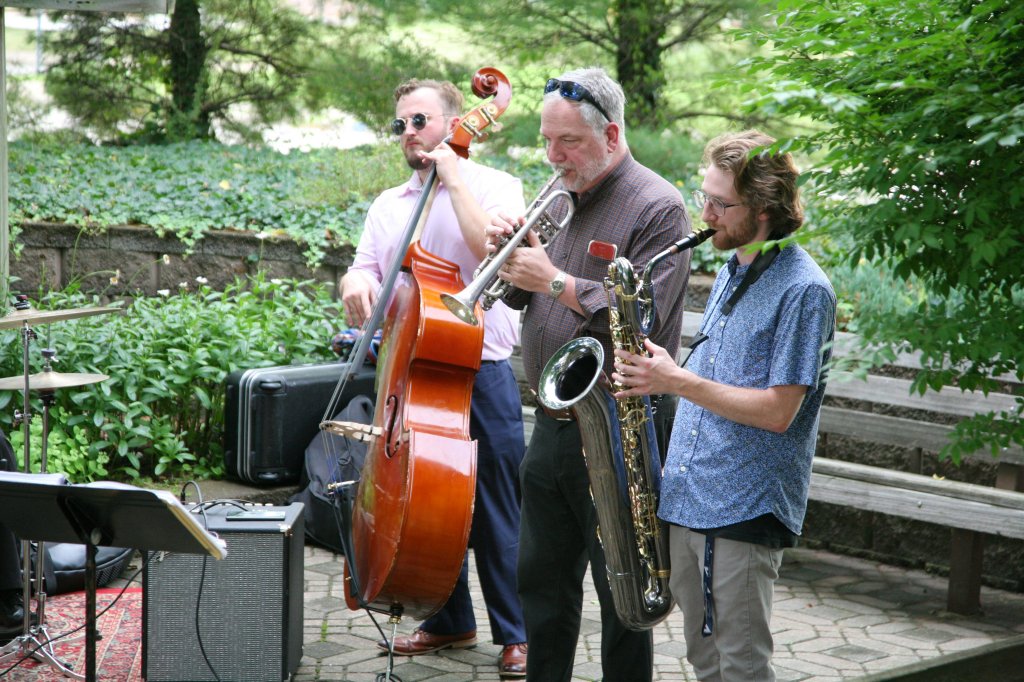 Three band members perform outside